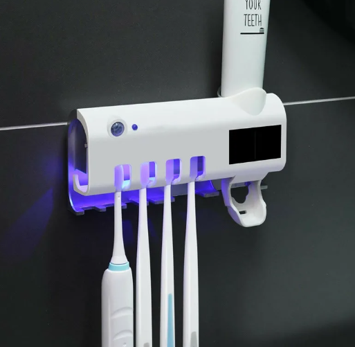 Dispenser for toothpaste and brushes with UV sterilizer