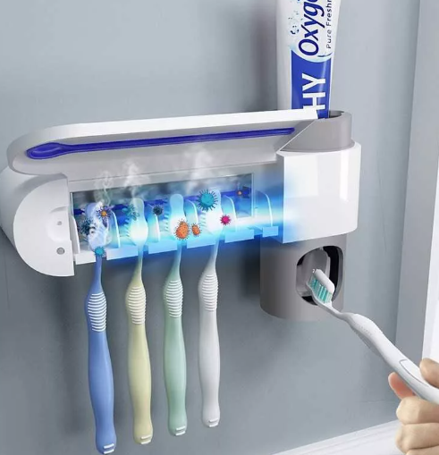 Dispenser for toothpaste and brushes with UV sterilizer