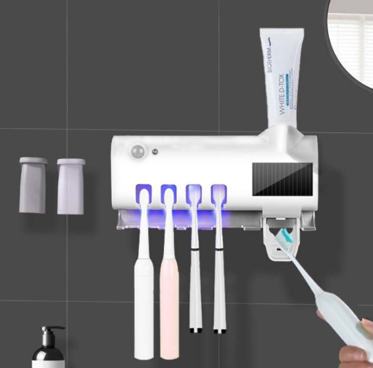 Dispenser for toothpaste and brushes with UV sterilizer