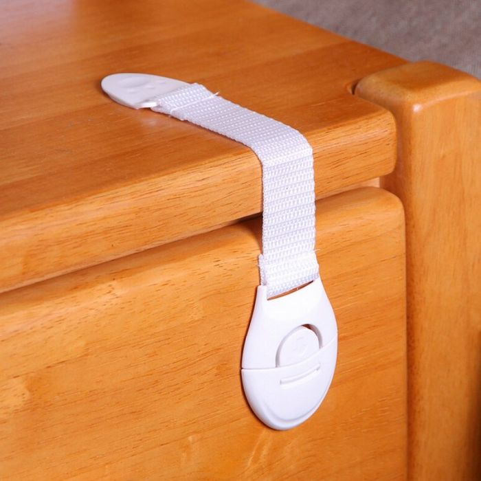 Door and drawer lock with protective fabric