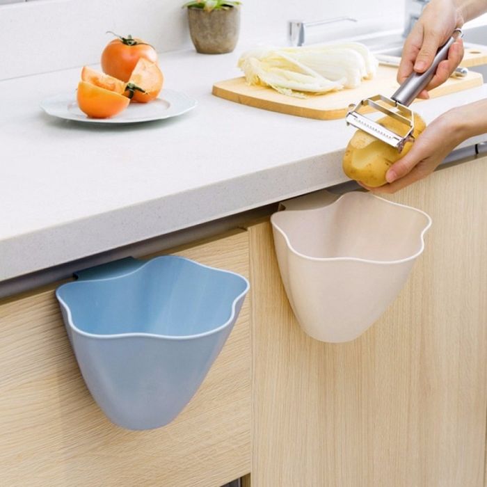 Plastic hanging wastebasket with attachment to cupboard door